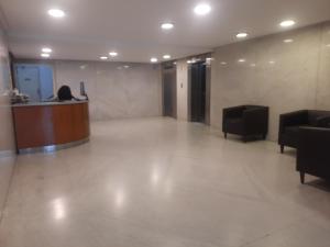 a lobby with a desk and chairs in a building at C&MHouse in Buenos Aires