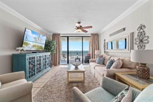 a living room with a couch and a tv at Bluewater Unit 404 in Orange Beach