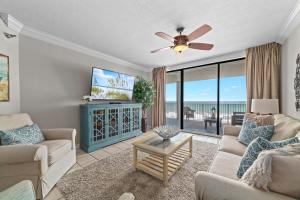 a living room with a couch and a ceiling fan at Bluewater Unit 404 in Orange Beach