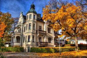 a large white house with a green roof at Villa Steiermark in Bad Reichenhall