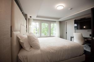 a bedroom with a white bed and a window at the reid hotel in Vanderhoof +17 photos
