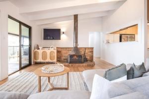 a living room with a couch and a fireplace at Montville Retreat With Hinterland & Coastal Views in Montville +21 photos