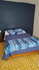 a bedroom with a bed with two pillows on it at Linda Casa en Tepoztlan centro 1 in Tepoztlán +23 photos