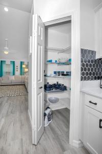 a kitchen with an open door to a pantry at Family friendly paradise Pool Home! in Palm Bay