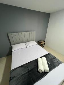 a bedroom with a bed with two white pillows at Hotel Casa Florida 70 Medellin in Medellín