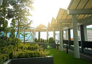 a view of a building with columns and plants at Ipoh Octagon Premium 7 Pax Condo One Free Parking by City Home Empire in Ipoh