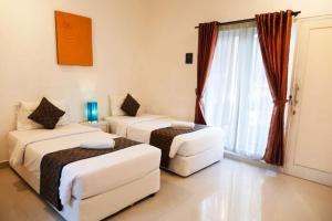 Letto o letti in una camera di Gaing Mas Residence By Gaing Mas Group