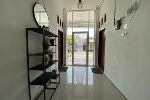a hallway with a black book shelf in a house at Guesthouse Pondok Amak in Padang +19 photos