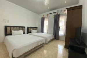 Ένα ή περισσότερα κρεβάτια σε δωμάτιο στο Guesthouse Pondok Amak
