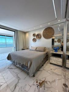 a bedroom with a bed and a dog in it at Casa Perola do Tapajós - Quartos privativos in Santarém