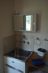 a kitchen with a sink and a mirror at Blackbutt The Shack at Gilinlea in Benarkin +19 photos