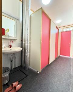 a bathroom with pink sliding doors and a sink at Tengudaira Mountain Lodge in Tateyama