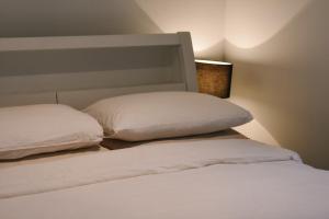 a bedroom with two white pillows on a bed at Cosy Cottage in Geraldton - "Moresby Rest" in Bluff Point