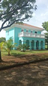 a blue house with a tree in front of it at Casa Brisa, Gran Pacifica in Managua