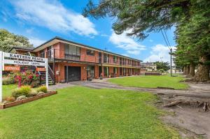 an apartment building with a sign in front of it at Eastern Beach Unit 2 in Port Fairy