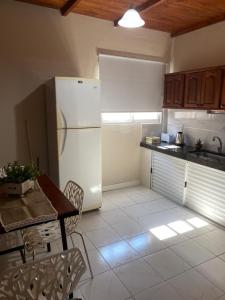 a kitchen with a refrigerator and a table with chairs at Oc temporarios in Paso de los Libres