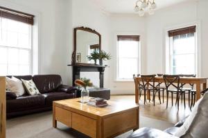 a living room with a couch and a table at The Hive Apartment in Beechworth