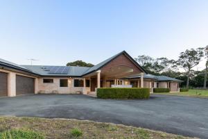 a house with solar panels on the roof at Luxury Range Stay! 6 Bedroom 4 Bathroom in Thornlands
