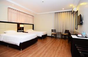 Postel nebo postele na pokoji v ubytování Ever O Business Hotel
