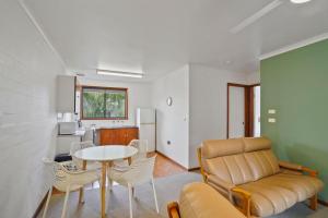 a living room with a couch and a table at Eastern Beach Unit 5 in Port Fairy