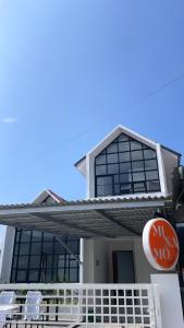 a house with a sign on the front of it at Minamo Homestay Modern Tengah Kota Payakumbuh in Payakumbuh