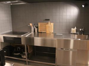 a kitchen with a stainless steel counter in a kitchen at 宮崎 海辺の貸別荘 noiro 野島 in Miyazaki +87 photos