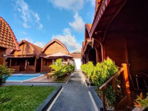 a villa with a swimming pool in a resort at Aming Villa Balangan in Jimbaran