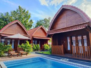a villa with a swimming pool in a resort at Aming Villa Balangan in Jimbaran