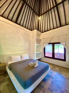 Rúm í herbergi á Lazy Inn Kuta Lombok