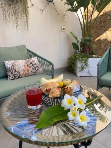 a coffee table with a plate of food and a drink at B&B La mia Isola in Castelluzzo