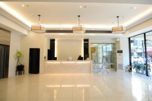 a lobby with a reception desk in a building at Ever O Business Hotel in Zamboanga