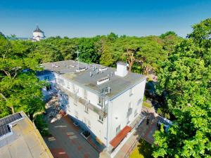 an overhead view of a white building in the forest at Ośrodek TVP in Ciechocinek