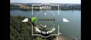 an aerial view of a lake with a sign on it at GreenKris in Ostaszewo