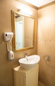a bathroom with a sink and a mirror at Casa del Monte - Dorna Arini in Dorna Arini