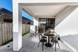 a patio with a table and chairs on it at Luxury home away from home in Mickleham