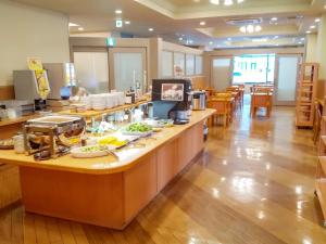 a restaurant with a counter with food on it at Hotel Route-Inn Aomori Ekimae in Aomori