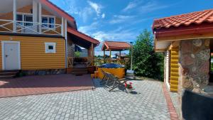 a house with a patio in front of it at Edelweiss Holiday House - Šventoji in Palanga
