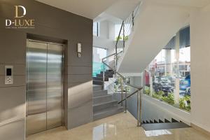 a lobby of a building with a elevator at D-Luxe Hotel in Cochin
