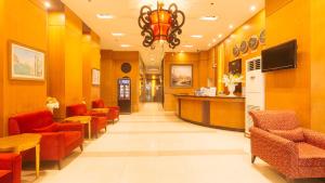 a waiting room with red chairs and a bar at Torre Venezia Suites in Manila