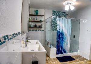 a bathroom with a sink and a shower at The Beach Pad Puntas in Rincon +174 photos