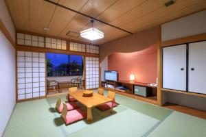 a room with a table and chairs and a dining room at Hill Hotel Sunpia Iga in Iga