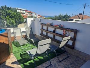 a group of chairs on a patio with a fence at Casa Do Cais in Setúbal