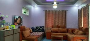 a living room with a couch and a chair at Tiny Holiday Home in Dakshīnkāli