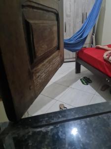 a room with a bed and a table and a door at Delta confot hostel in São Luís