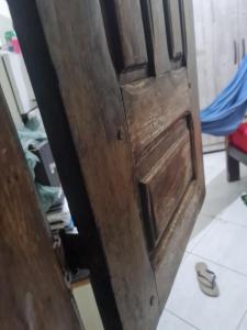 a wooden door in a room with at Delta confot hostel in São Luís