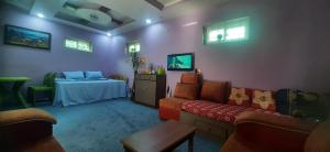 a living room with a couch and a table at Tiny Holiday Home in Dakshīnkāli