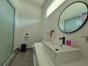 a white bathroom with a sink and a mirror at Sea Love Beach Bar & Bungalows in Ban Tai +37 photos