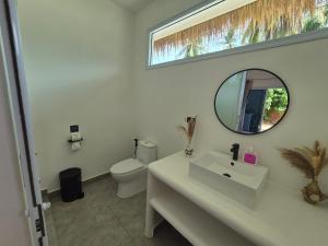 a bathroom with a white sink and a mirror at Sea Love Beach Bar & Bungalows in Ban Tai