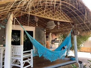 a hammock on the porch of a house at Sea Love Beach Bar & Bungalows in Ban Tai