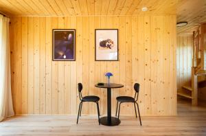 a dining room with a table and two chairs at Apartamenty & Pokoje MyWy in Zakopane